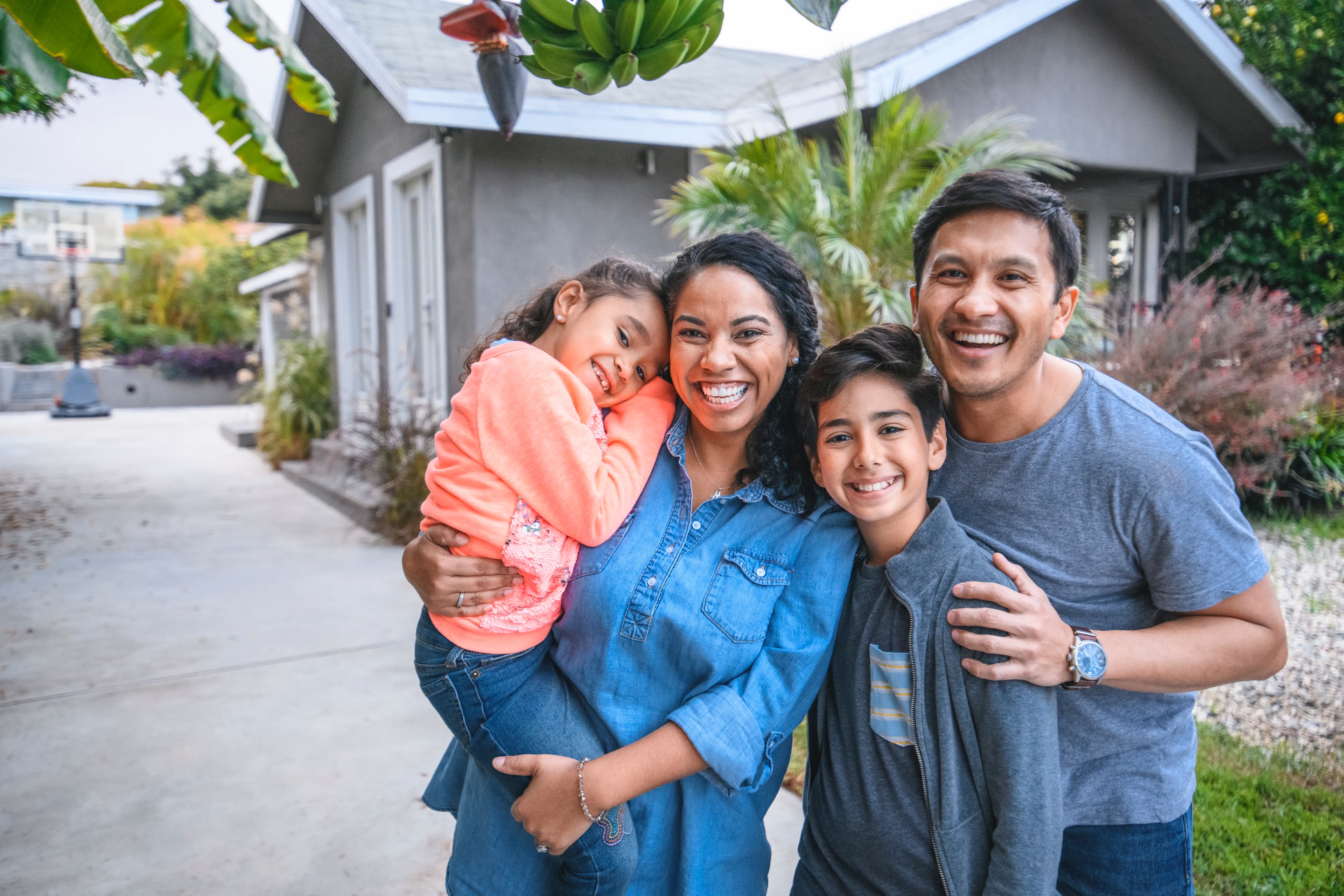 A family in the driveway of their California home shopping today's purchase mortgage rates