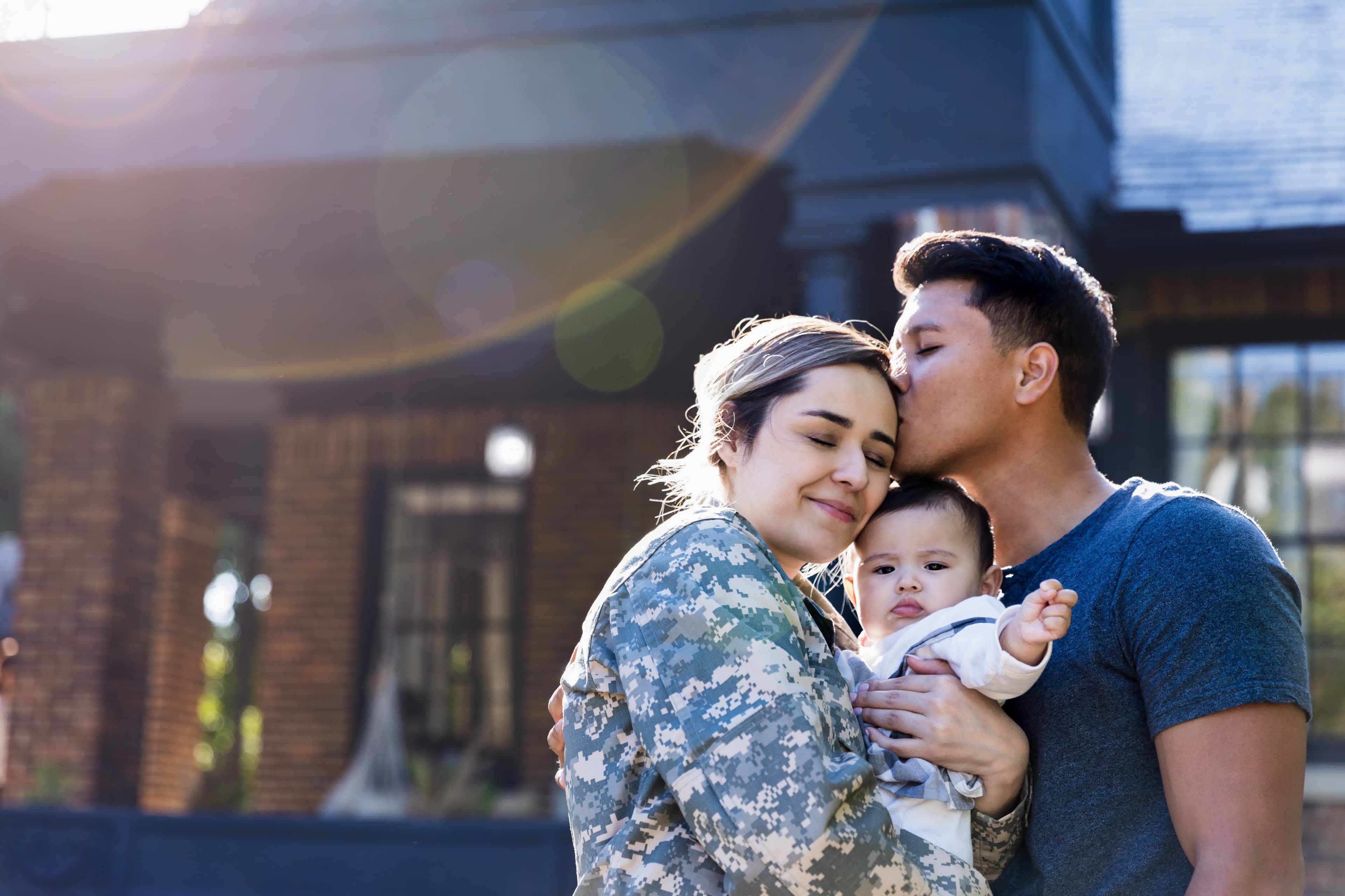 A military servicewoman in uniform with her family checking today's VA rates