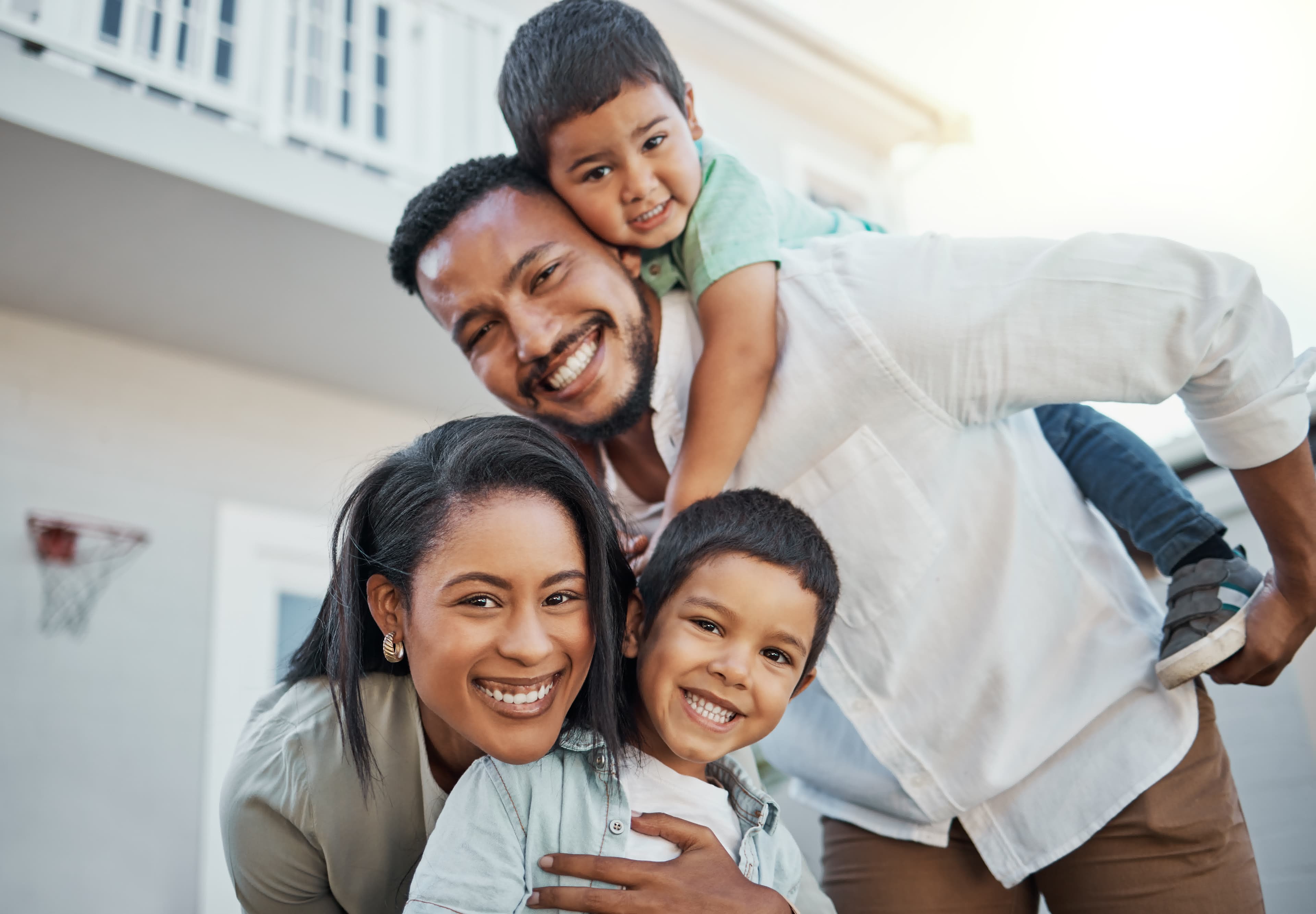 A happy family outside their first home bought with a first-time buyer program