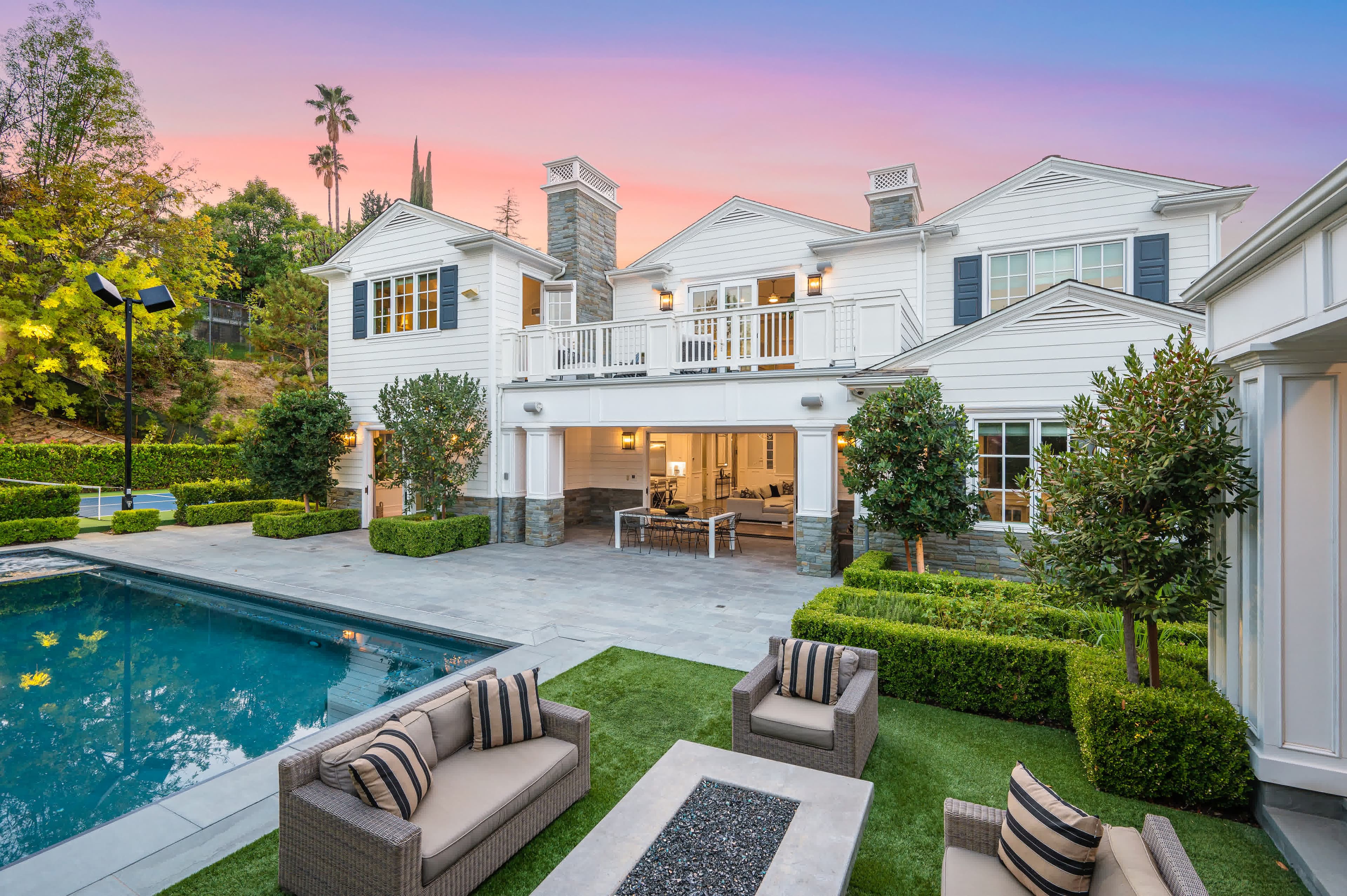 A luxury backyard pool at sunset beside a California second home