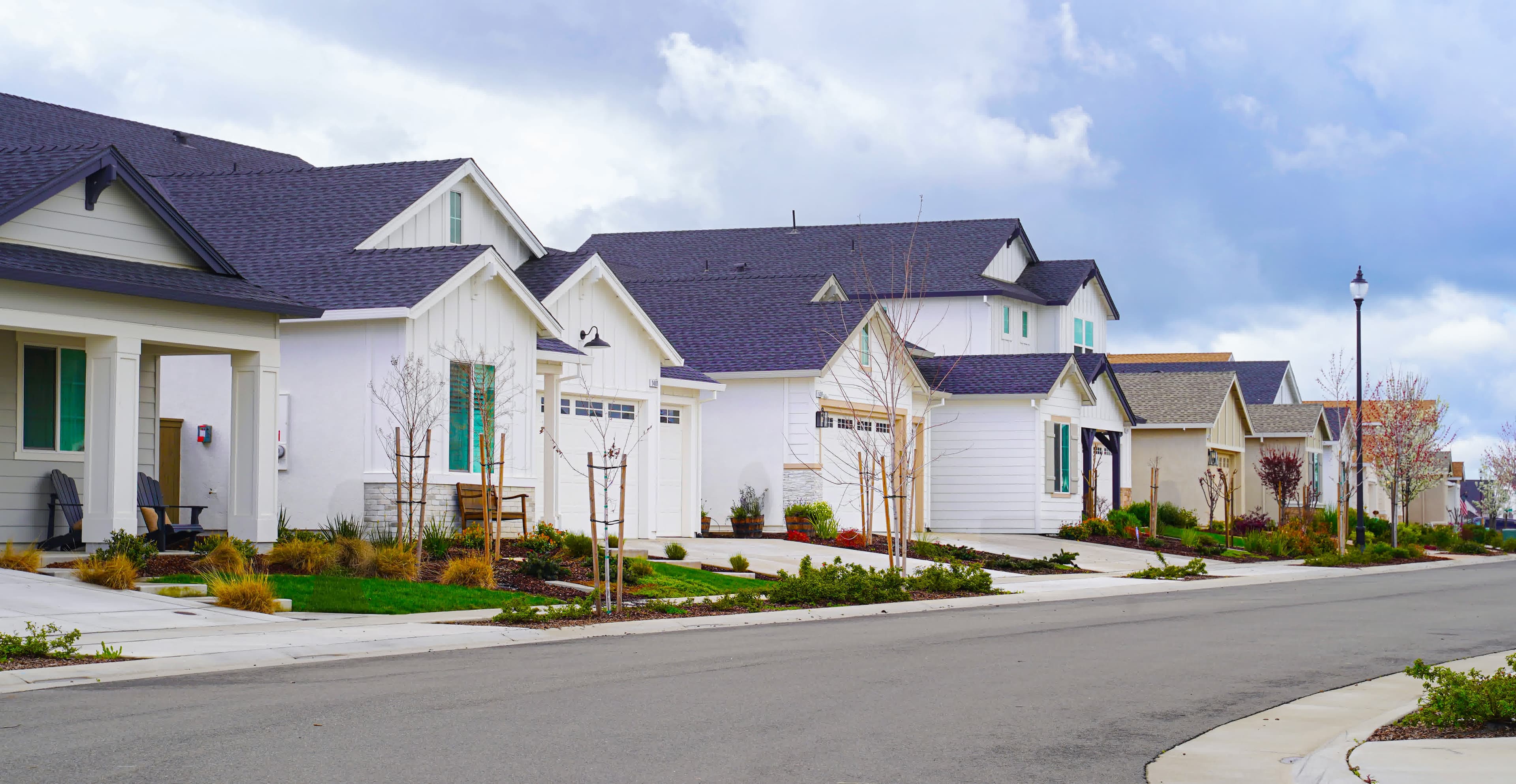 A row of California multi-unit homes on a quiet street