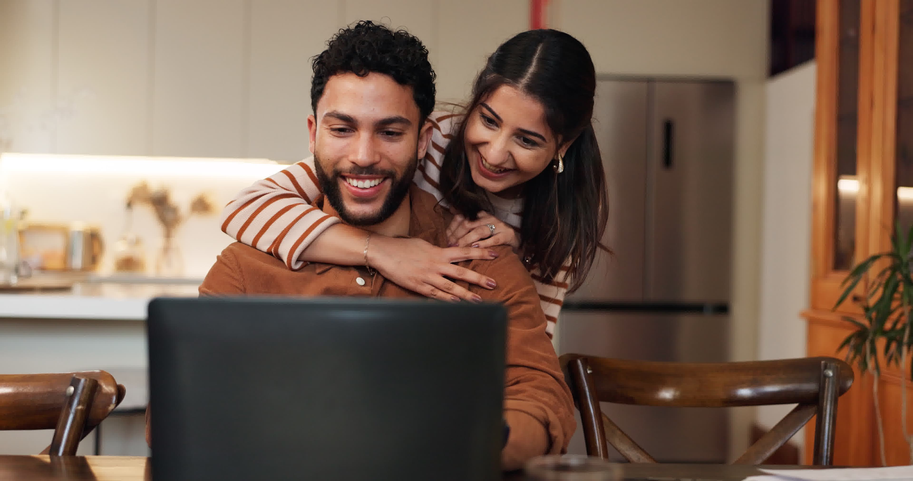 Couple reviewing their personalized refinance rate on a laptop at home