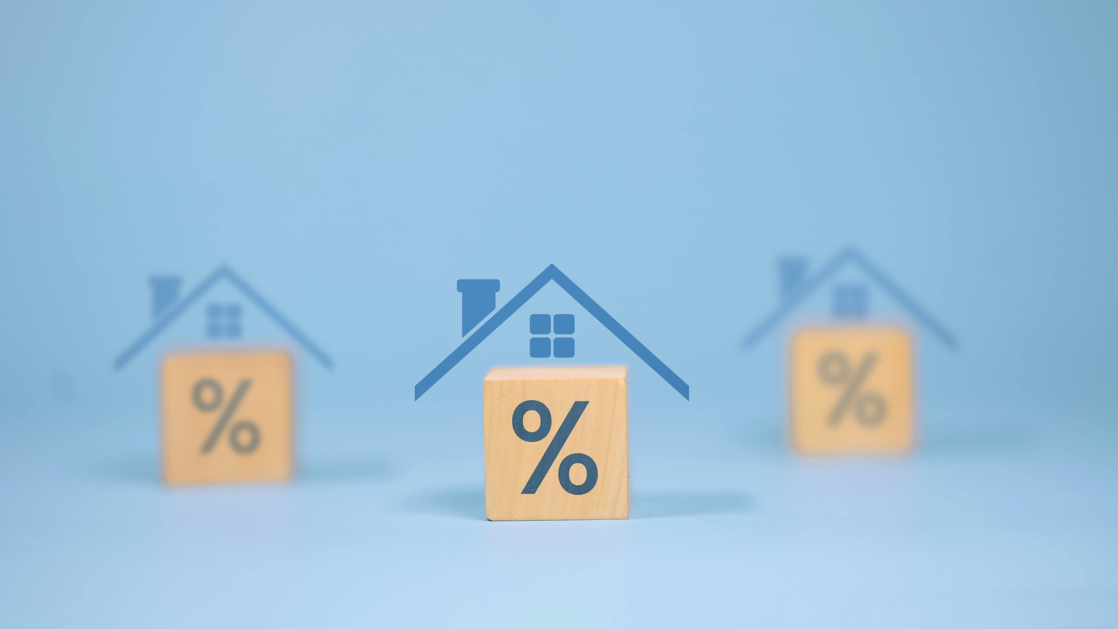 Wooden percent blocks under house roofs representing a piggyback 80-10-10 loan structure