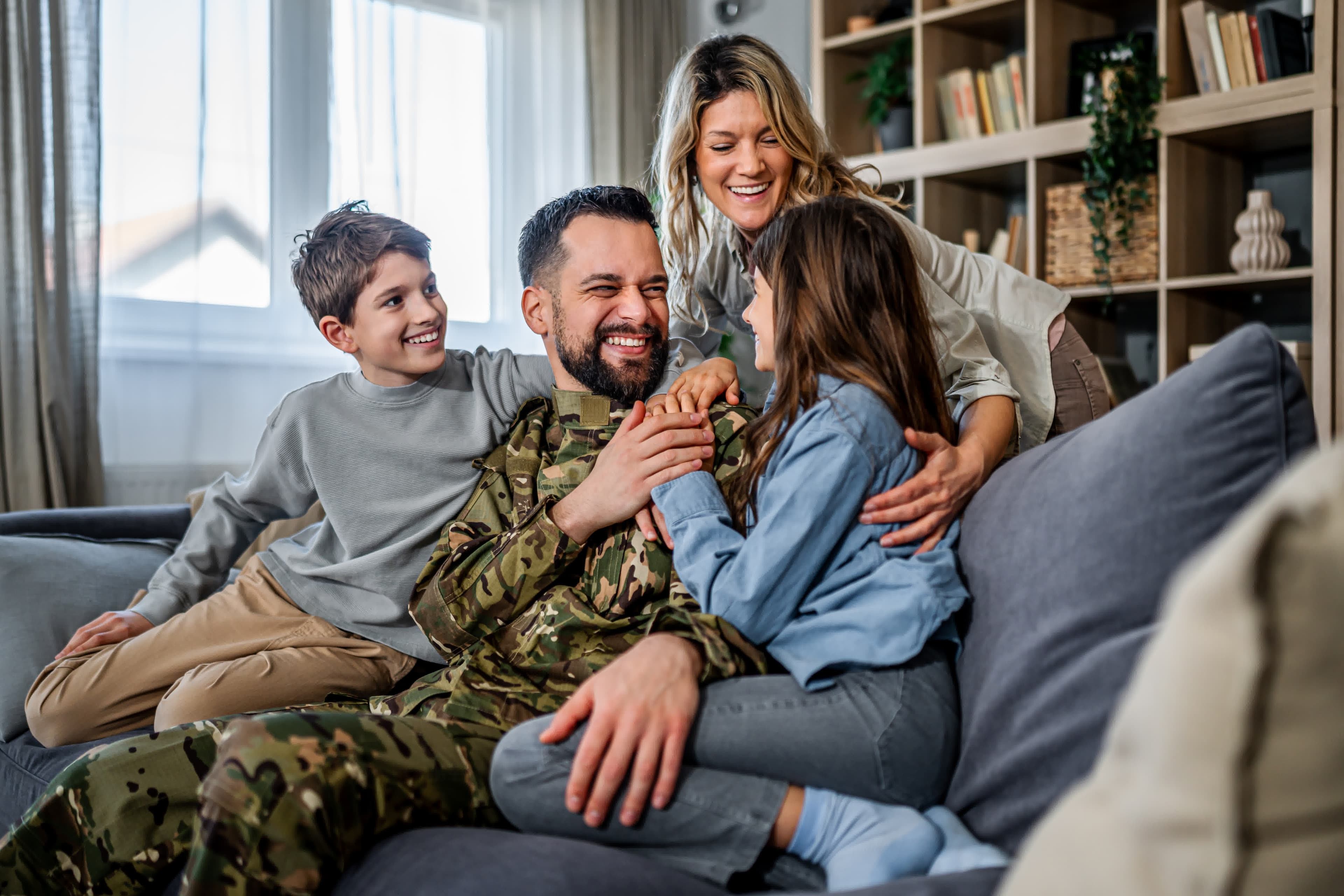 A military service member relaxing with family at home after a VA IRRRL streamline refinance