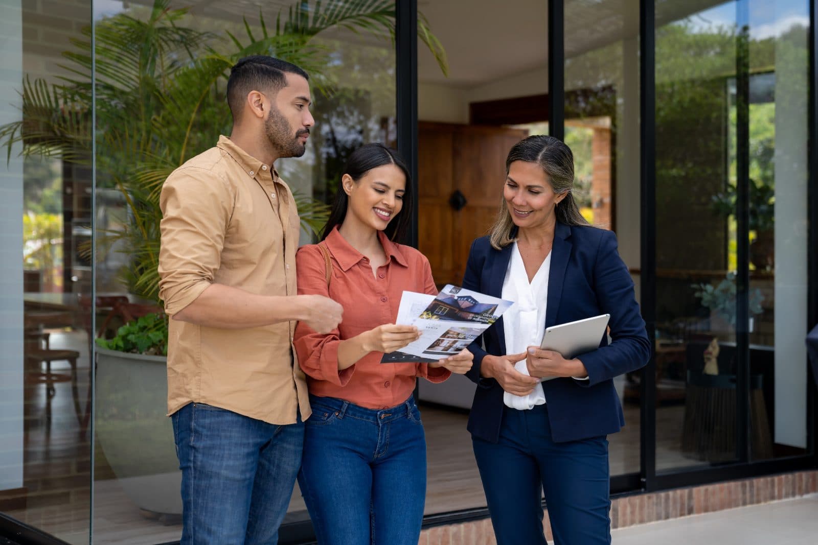 A friendly California real estate agent showing a home to a couple